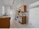 This kitchen has white appliances, wood cabinets, tile flooring, and updated lighting at 11113 Sylvan Pond Cir, Orlando, FL 32825