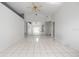 Living room featuring neutral paint, high ceilings, updated lighting, and tile flooring at 11113 Sylvan Pond Cir, Orlando, FL 32825
