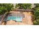 Aerial view of a screened-in pool and well-maintained wooden fence in a private backyard at 11113 Sylvan Pond Cir, Orlando, FL 32825