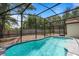Sparkling pool enclosed in a screened-in area, providing a refreshing oasis in a tranquil backyard setting at 11113 Sylvan Pond Cir, Orlando, FL 32825