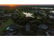 Stunning aerial view of a neighborhood at sunset, with serene lakes and lush greenery at 11335 Winston Willow Ct, Windermere, FL 34786