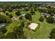 Expansive community view featuring tennis court, basketball court, playground and lush green space at 11335 Winston Willow Ct, Windermere, FL 34786