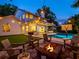 Relaxing backyard with a fire pit, string lights, outdoor furniture, and a sparkling swimming pool at 11335 Winston Willow Ct, Windermere, FL 34786