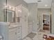 Stylish bathroom with marble floors, white cabinets, a double vanity, and a glass shower at 11335 Winston Willow Ct, Windermere, FL 34786