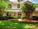 Inviting two-story home with mature trees, manicured lawn, and rocking chair on the porch at 11335 Winston Willow Ct, Windermere, FL 34786