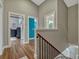 Hallway with hardwood floors and a staircase leading to various rooms within the home at 11335 Winston Willow Ct, Windermere, FL 34786