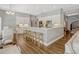 Open kitchen featuring white cabinets, stainless steel appliances, an island with seating and hardwood floors at 11335 Winston Willow Ct, Windermere, FL 34786