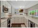 Modern kitchen with white cabinets, white countertops, stainless steel appliances, and an island with barstool seating at 11335 Winston Willow Ct, Windermere, FL 34786