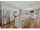 Modern kitchen with white cabinets, stainless steel appliances, bar stool seating, and an open layout to the living area at 11335 Winston Willow Ct, Windermere, FL 34786