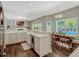 Modern kitchen with white cabinets, a kitchen island with seating, and an open layout to a comfortable living area at 11335 Winston Willow Ct, Windermere, FL 34786
