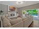 Bright living room with fireplace, large sofa and access to a pool and outdoor dining area at 11335 Winston Willow Ct, Windermere, FL 34786