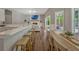 Open-concept living room with a kitchen island, a fireplace, a dining area, and sliding glass doors to the patio at 11335 Winston Willow Ct, Windermere, FL 34786
