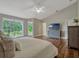 Spacious main bedroom with hardwood floors, a sitting area, and large windows providing scenic views at 11335 Winston Willow Ct, Windermere, FL 34786