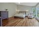 Cozy main bedroom with hardwood floors, a sitting area, neutral paint, and ample natural light at 11335 Winston Willow Ct, Windermere, FL 34786
