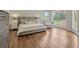 Stylish main bedroom featuring hardwood floors, a sitting area, and large windows overlooking the yard at 11335 Winston Willow Ct, Windermere, FL 34786