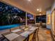 Covered patio with outdoor dining and a beautiful swimming pool creates the perfect backyard oasis at 11335 Winston Willow Ct, Windermere, FL 34786