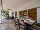 Covered patio with slate flooring, dining table, and comfortable seating, perfect for outdoor entertaining at 11335 Winston Willow Ct, Windermere, FL 34786