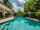 Refreshing pool surrounded by lush landscaping and an elegant black fence with ample room for entertaining at 11335 Winston Willow Ct, Windermere, FL 34786