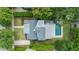 An aerial shot of a house with a pool, patio, lush greenery, and detailed roof design at 1207 W New Hampshire St, Orlando, FL 32804