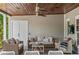 Well-furnished back porch with ceiling fan, perfect for lounging and enjoying the outdoors at 1207 W New Hampshire St, Orlando, FL 32804