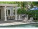 Inviting back porch featuring a dining area, grill, lounge chairs, and swimming pool at 1207 W New Hampshire St, Orlando, FL 32804