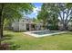 Backyard with swimming pool, outdoor living area, and mature trees at 1207 W New Hampshire St, Orlando, FL 32804