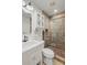 Well-lit bathroom with a vanity, toilet, and enclosed tiled shower at 1207 W New Hampshire St, Orlando, FL 32804