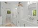 Elegant bathroom featuring double vanities, marble countertops, and a classic, bright aesthetic at 1207 W New Hampshire St, Orlando, FL 32804