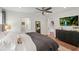 Spacious bedroom featuring a large bed, television, dark dresser, and an ensuite bathroom at 1207 W New Hampshire St, Orlando, FL 32804