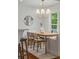 Bright dining room with a modern chandelier, round mirror, and large window view at 1207 W New Hampshire St, Orlando, FL 32804