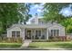 Charming single-Gathering home showcasing a landscaped front yard, covered porch, and craftsman architecture at 1207 W New Hampshire St, Orlando, FL 32804