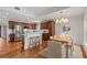 Open concept kitchen with stainless steel appliances, wood cabinets, and adjacent dining area at 1207 W New Hampshire St, Orlando, FL 32804