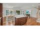 Open kitchen with stainless appliances, center island, dining area, hardwood floors, and access to backyard at 1207 W New Hampshire St, Orlando, FL 32804