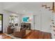 Inviting living room with hardwood floors, cozy seating, and a stylish console with an artistic display at 1207 W New Hampshire St, Orlando, FL 32804