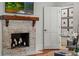 Inviting living room with a fireplace, TV, and an open doorway at 1207 W New Hampshire St, Orlando, FL 32804