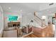 Cozy living room featuring hardwood floors, shiplap walls, and a staircase to the upper level at 1207 W New Hampshire St, Orlando, FL 32804