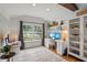 Bright home office features a large window, custom built-ins, shelving, and a stylish rug at 1207 W New Hampshire St, Orlando, FL 32804