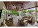Outdoor deck with covered seating area, dining area, and poolside lounge chairs at 1207 W New Hampshire St, Orlando, FL 32804