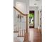 Interior view of the staircase with wood treads, white risers, and an inviting entryway with wood floors at 1207 W New Hampshire St, Orlando, FL 32804