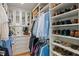 Organized walk-in closet with custom shelving, mirrored cabinets, and ample storage space at 1207 W New Hampshire St, Orlando, FL 32804