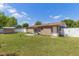 Spacious backyard with green grass, shed, and white picket fence, perfect for outdoor enjoyment at 1219 Blue Spring Ct, Ocoee, FL 34761