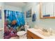 Bathroom with a colorful shower curtain and nautical decor at 1219 Blue Spring Ct, Ocoee, FL 34761