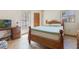 Cozy bedroom with a wooden bed frame and natural lighting at 1219 Blue Spring Ct, Ocoee, FL 34761