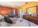 Cozy bedroom featuring vibrant accent wall, television, and comfortable furnishings at 1219 Blue Spring Ct, Ocoee, FL 34761