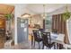 Cozy dining room adjacent to kitchen features stylish chandelier and comfortable seating at 1219 Blue Spring Ct, Ocoee, FL 34761