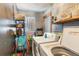 Practical laundry room with washer and dryer hookups, shelving, and storage space at 1219 Blue Spring Ct, Ocoee, FL 34761