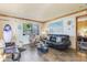 Comfortable living room featuring tile floors, natural light, and charming decor at 1219 Blue Spring Ct, Ocoee, FL 34761