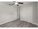 This bedroom features wood-look floors, closet, and a ceiling fan at 13 Fanfair Ave, Orlando, FL 32811