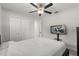 Bright bedroom features a ceiling fan, a TV, and double door closets at 13 Fanfair Ave, Orlando, FL 32811
