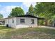 Well-kept single story home featuring a covered front porch, painted brick and manicured lawn at 13 Fanfair Ave, Orlando, FL 32811